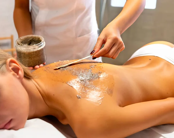 Body peeling massage. The photo shows the patient and the masseuse.