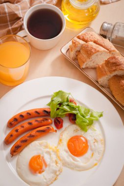 Kahvaltıda kızarmış yumurta ve sosis.