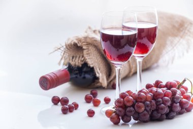 Kırmızı şarap ve üzüm, beyaz arka plan.