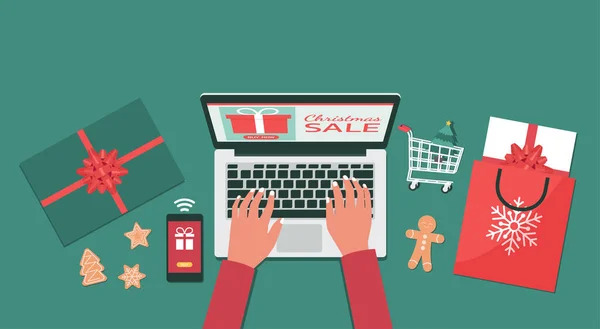 Noel çevrimiçi alışverişi ya da kış tatili üst görünüm konsepti, insan eli akıllı telefon hediye kutuları ve alışveriş torbalarıyla dizüstü bilgisayarda sipariş verir, düz serili illüstrasyonlar