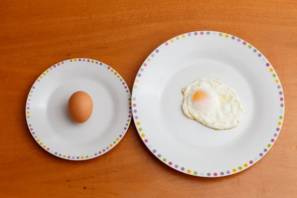 Raw egg and fried egg — Stock Photo, Image