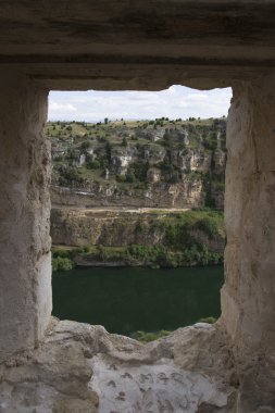 Duraton river view from a window in ruins clipart