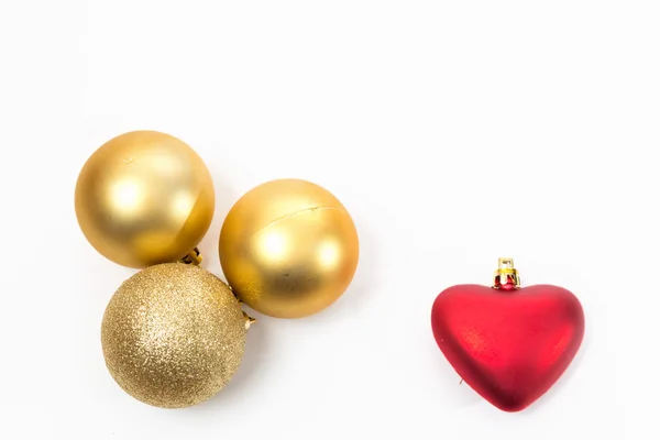 Christmas golden balls and a red heart — Stock Photo, Image