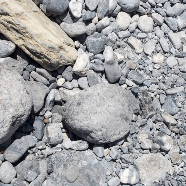 Abstrakt bild av stenar och småsten på en grekisk strand — Stockfoto