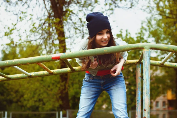 Portrait of fashionable girl in a cap and a denim jacket in the — Stock Photo, Image