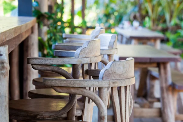 Old wooden chair in front of bar — Stock Photo, Image