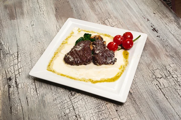 Juicy grilled beef steak and mushrooms with tomatoes and mustard — Stock Photo, Image