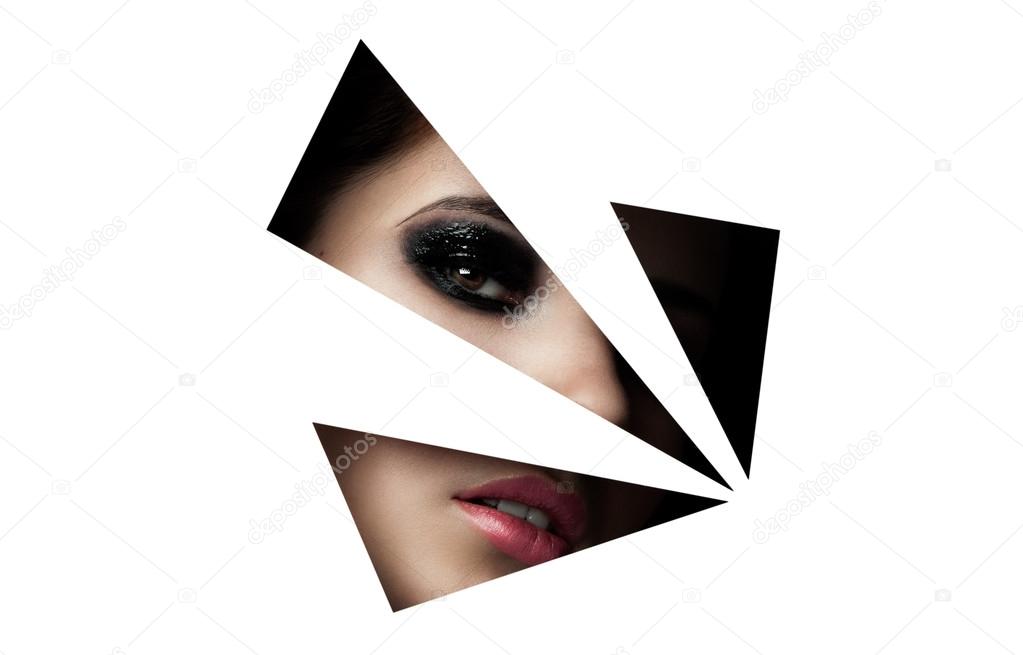 Beauty model with makeup through paper triangles