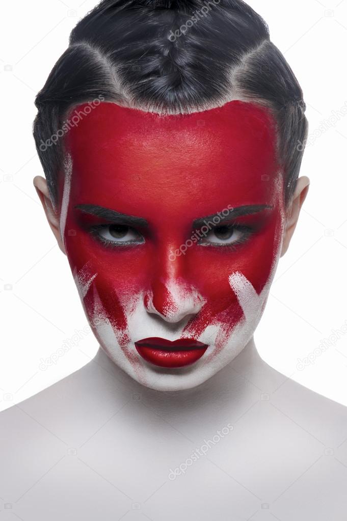 Young female model with red lips and blood on face