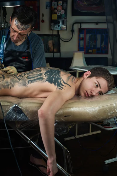 Tattooed man lying on the table