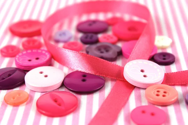 Pink and purple haberdashery buttons and craft ribbon — Stock Photo, Image