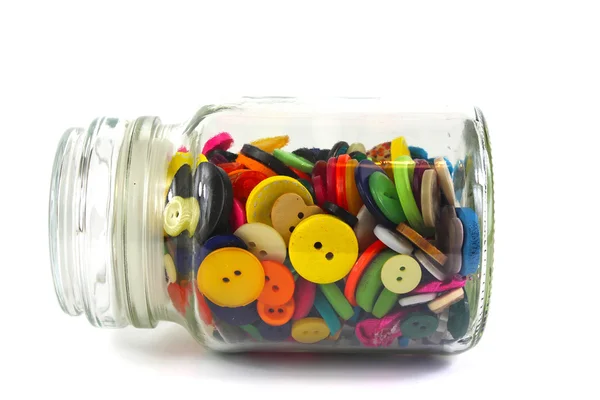 Kleurrijke fournituren knoppen in een glazen pot — Stockfoto
