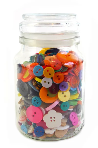 Coloridos botones de mercería en un frasco de vidrio. Vertical sobre blanco —  Fotos de Stock