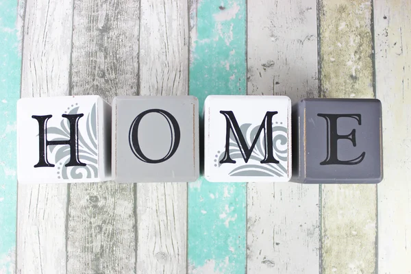 Home sign on a distressed wooden background with turquoise tones — Stock Photo, Image