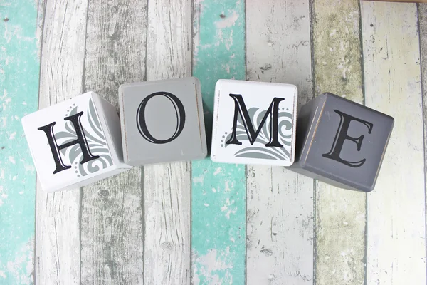 Home sign on a distressed wood background with turquoise tones. — Stock Photo, Image