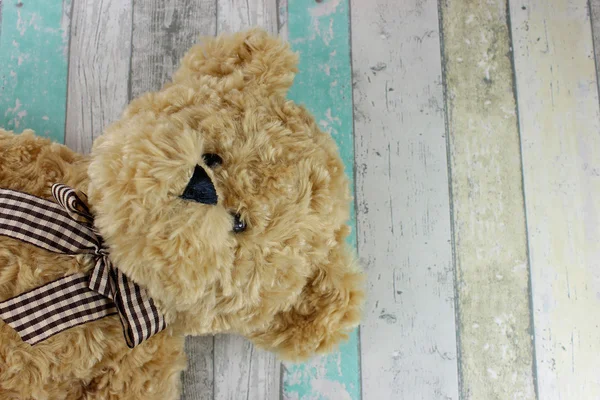 Teddy bear on a distressed wood background. — Stock Photo, Image