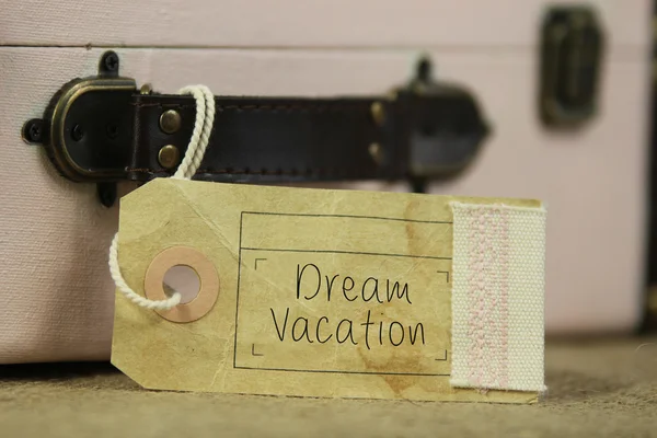 Dream vacation tag on vintage suitcase — Stock Photo, Image