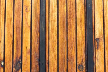 Her tahta arasında koyu bir dikişli, kırsal ahşap desen yakın plan.