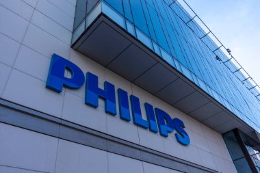 Suresnes, France - April 13, 2021: Logo on the facade of the French headquarters of Philips, an international Dutch group specializing in household appliances, medical equipment and lighting clipart