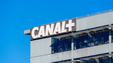 Boulogne-Billancourt, France - June 6, 2021: Logo at the top of the headquarters building of Canal+ . Canal+ is a private French national pay television channel focused on cinema and sport clipart