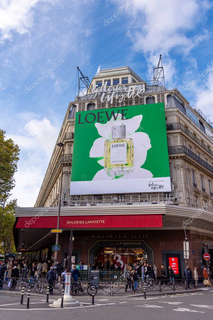 Paris, France - October 24, 2025: Large advertising billboard for Loewe perfumes covering the facade of the Galeries Lafayette, a famous department store of Paris, France