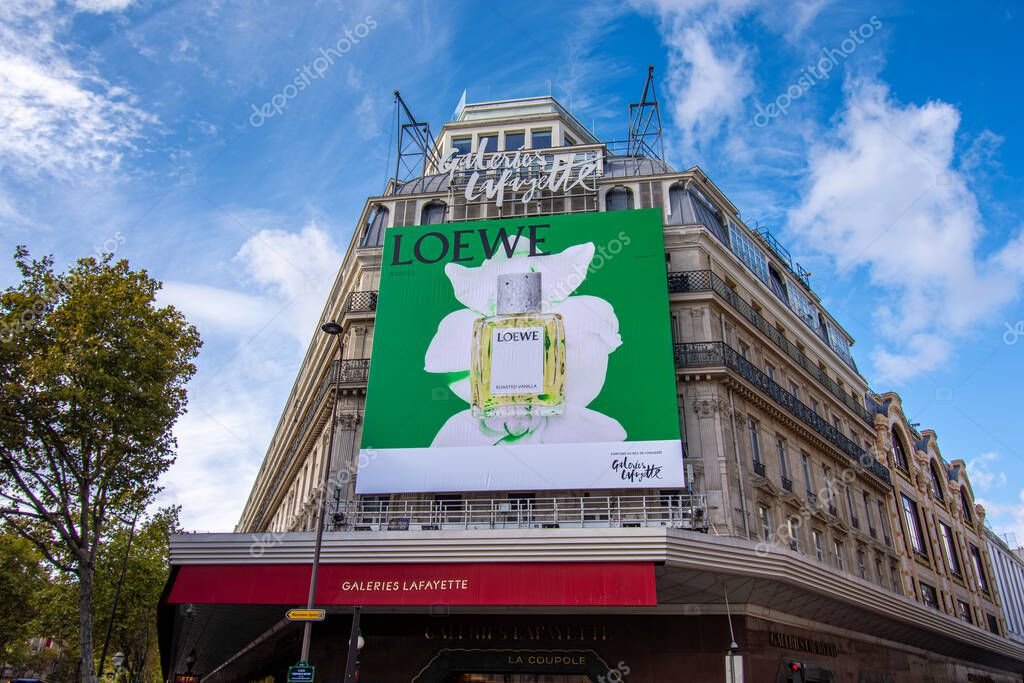 Paris, France - October 24, 2025: Large advertising billboard for Loewe perfumes covering the facade of the Galeries Lafayette, a famous department store of Paris, France
