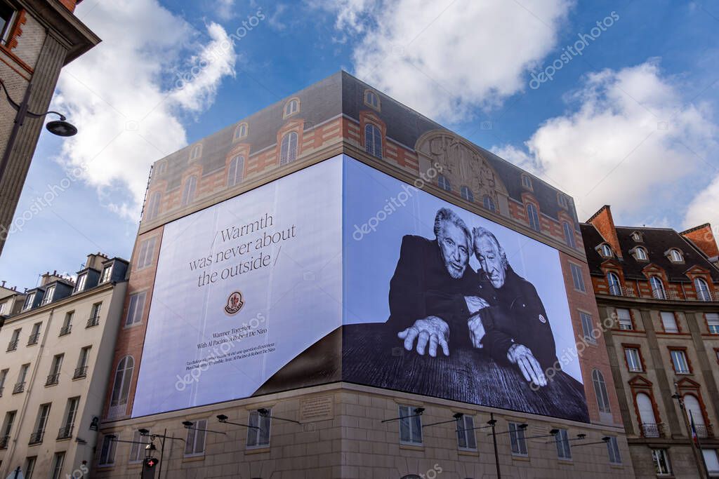Paris, France - October 30, 2025: Large advertising billboard for Moncler, an Italian luxury fashion brand, starring actors Al Pacino and Robert De Niro, covering the facade of a Parisian building
