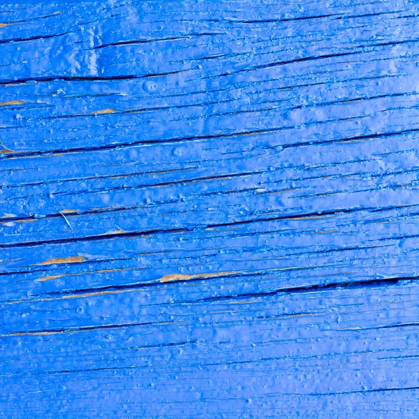 Bakgrund konsistens av den gamla blå målade styrelsen i sprickorna. kvadrat foto med kopiera utrymme för text — Stockfoto