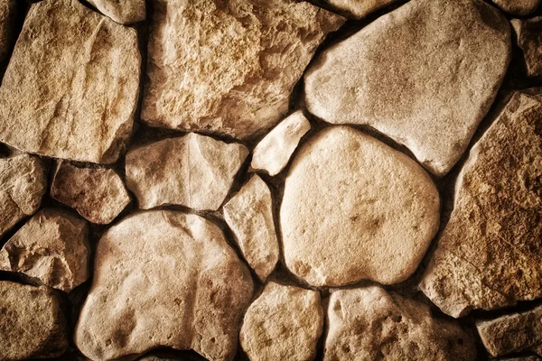 Textura de fondo de una pared forrada con piedra natural primer plano, foto tonificada — Foto de Stock