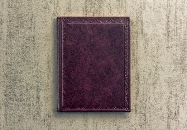 purple book on a grey grunge background, top view, retro toned image