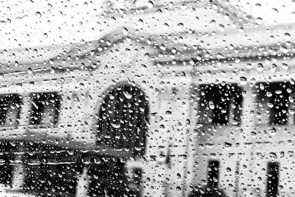view of the street through the window of the car in rainy weather in black and white