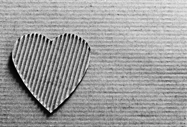 Valentine - heart symbol carved out of corrugated cardboard. Copy space. Free space for text, Close-up, top view. Black and white photo — Stock Photo, Image