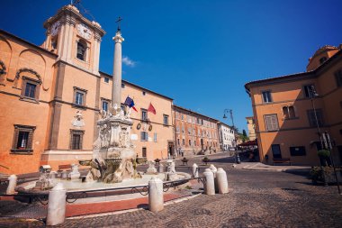 Fountain and town hall in the square of Tarquinia (Italy) clipart