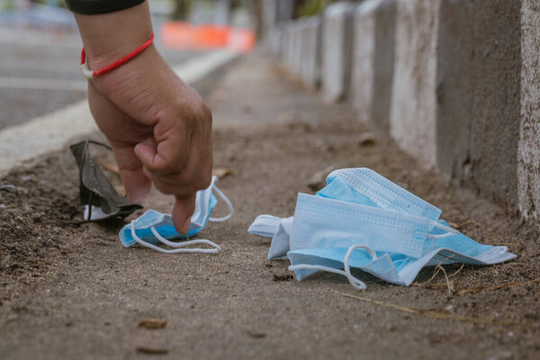 Medical masks used to prevent COVID-19 are left on walkways and are an environmental concern.