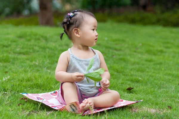 Children sitting in the courtyard lawn