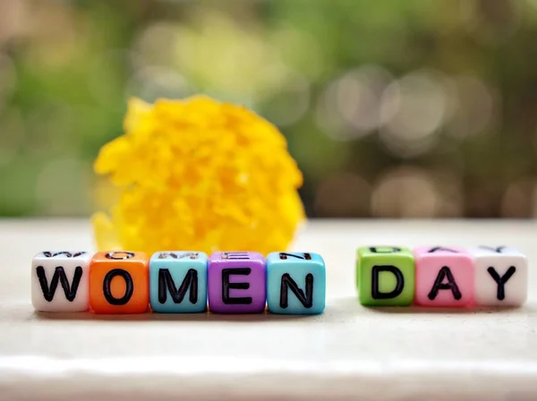 Colorful Alphabet Beads Happy Women Day Yellow Flower Garden Words — Stockfoto