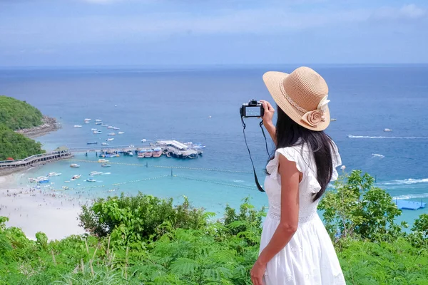 Asian women resting on sea beach with white dress she happy of outdoor summer on sand beach with blue sky and sea, well editing text present for your project with tourism and travel on summer season