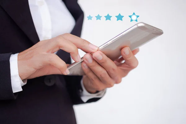 Hand staff business woman with black suit using mobile or smartphone with 5 star for rate satisfaction level with internet digital on white background. technology for business concept.