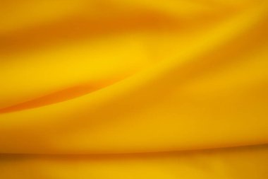 Altın veya sarı kumaş kumaş kumaş kumaş görünüm arkaplanı. yumuşak ipek lüks düz dalga duvar kağıdı. Fotokopi alanı olan düz ya da üst görünüm. Yaz tatili konsepti için arka plan.