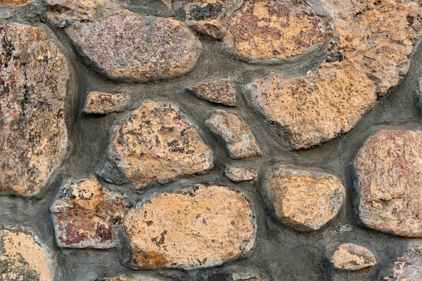 Närbild stenmur, kullersten murverk, sten bakgrund, kullersten mönster — Stockfoto