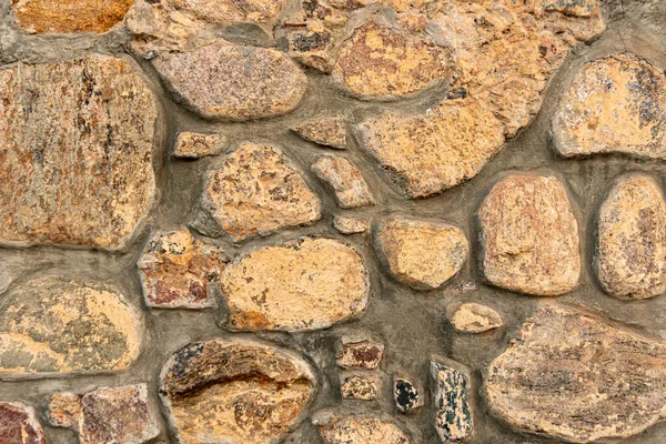 Cobblestone mönster, närbild stenvägg, kullersten murverk, sten bakgrund — Stockfoto