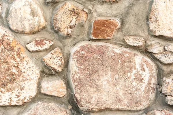 Närbild grå stenmur, kullersten murverk, brun sten bakgrund, kullersten mönster — Stockfoto