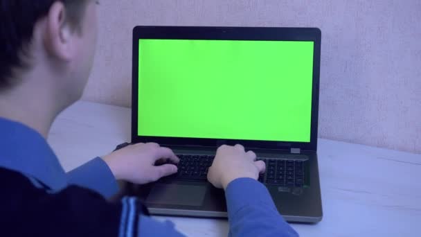 Un tipo emocionalmente enojado por una conexión remota en una videoconferencia y golpea sus puños contra una computadora portátil, pantalla verde — Vídeos de Stock