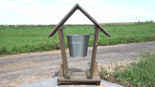 Unusual creative trash can or recycling bin near road in the form of a bucket sways in the wind, original landscape design — Stock Video