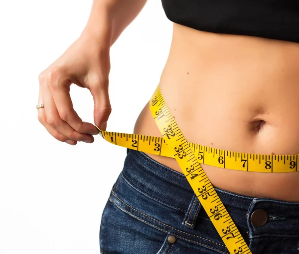 Woman measuring her waistline — Stock Photo, Image