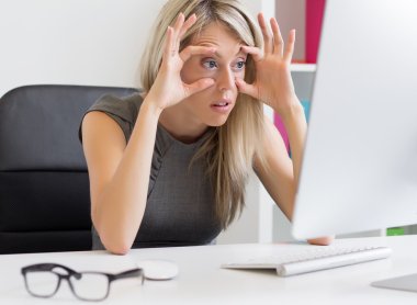 Tired woman in front of computer clipart