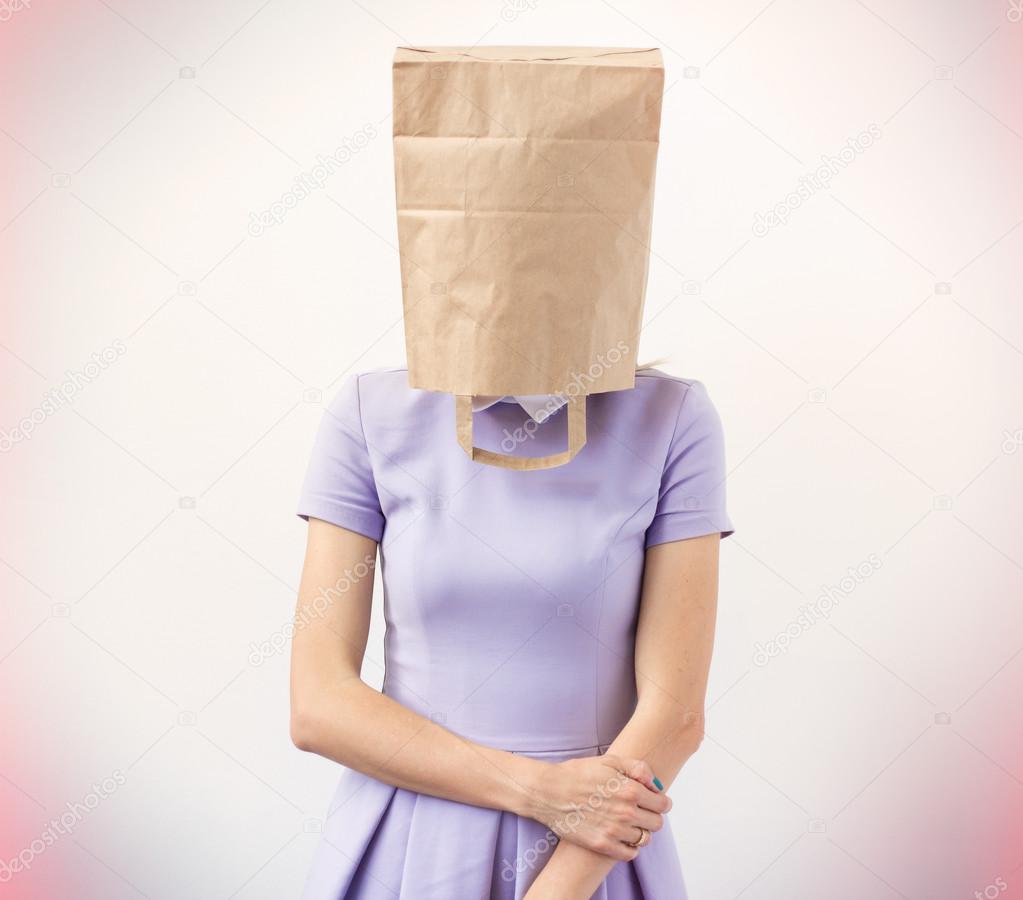 Young woman with paper bag over her head