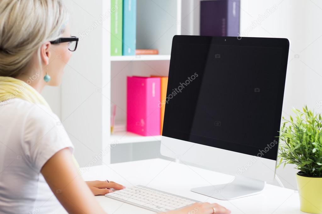 Young creative woman working with computer in the office