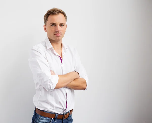 Portrait of young creative man standing with arms crossed Royalty Free Stock Images