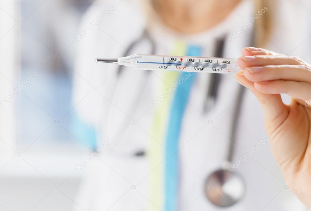 Doctor holding thermometer
